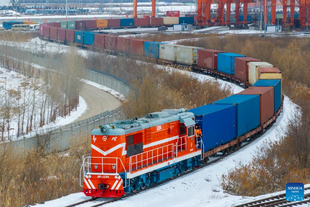 This aerial drone photo taken on Nov. 16, 2025 shows a China-Europe freight train departing from the transshipment yard of Tongjiang North Railway Station in Tongjiang City