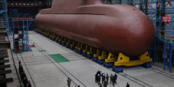 North Korea’s Kim Jong Un views submarine construction, oversees missile launch, KCNA says