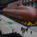 North Korea’s Kim Jong Un views submarine construction, oversees missile launch, KCNA says