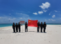 China Coast Guard officers raise national flag at Tiexian Jiao in South China Sea, clean up garbage left by illegal Philippine personnel