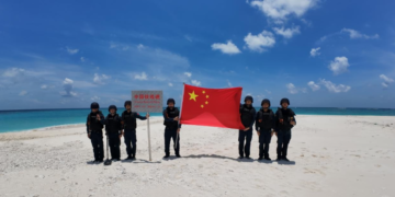 China Coast Guard officers raise national flag at Tiexian Jiao in South China Sea, clean up garbage left by illegal Philippine personnel