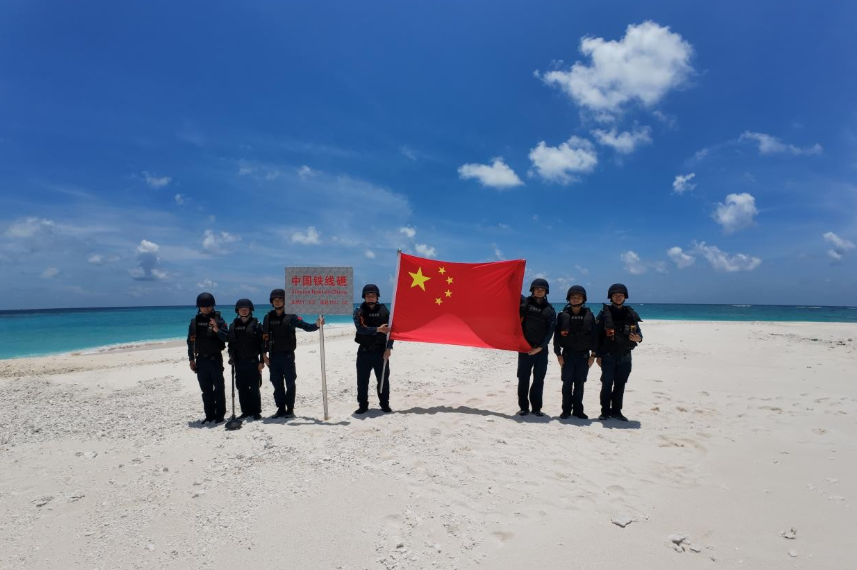 China Coast Guard officers raise national flag at Tiexian Jiao in South China Sea, clean up garbage left by illegal Philippine personnel